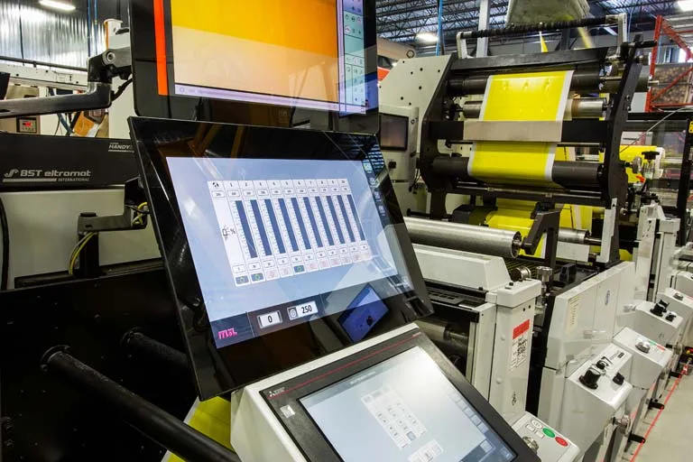 Custom label printing technology with digital control screens for high-quality product labels.